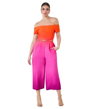 A-Ombre Bardot JSuit from Roman. Elevate your occasionwear this Summer with a vibrant ombre print jumpsuit! The perfect alternative to an occasion dress, this jumpsuit is cut in a flattering wide leg shape with culotte trousers and handy side pockets. Cinched in with a detachable metal belt, this ombre style has a striking gradient design and an even more flattering bardot neckline. Finishing off the shoulder with short sleeves, this stretch style has pleat details at the waist to create a feminine flow. Style yours with strappy heels for your next Summer event!