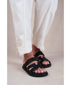 Step out in style with our Cut Out Strappy Slip On Flats in a fashionable and comfortable design. These flats are perfect for adding a touch of elegance to any outfit.
 
Key Features:


Chic Cut Out Design: The cut-out details create a stylish and unique look that sets these flats apart from ordinary slip-ons, adding a trendy and fashionable element to your ensemble.

Slip-On Style: The slip-on design allows for easy and convenient wear, making these flats a go-to option when you're on the go or need a comfortable yet fashionable shoe.

Comfortable Fit: These flats are designed to provide a comfortable fit with their soft and flexible construction, ensuring that your feet feel supported and relaxed throughout the day.

Versatile Style: The cut out strappy details and sleek silhouette make these flats versatile enough to be paired with a variety of outfits, from casual jeans to flowy dresses, for a sophisticated and put-together look.

Durable Construction: Crafted with high-quality materials, these flats are built to withstand regular wear and tear, ensuring their longevity and durability.

Cushioned Insole: The cushioned insole provides all-day comfort, allowing you to stay on your feet without any discomfort or fatigue.

Specifications:

Material: Faux leather
Colour: Available in multiple colours
Size Options: Available in multiple sizes
Closure: Slip-on style, Adjustable Strap
Sole: Rubber sole for comfort and traction

Invest in our Cut Out Strappy Slip On Flats and enjoy the perfect combination of style and comfort. These flats will elevate your outfits and leave you feeling effortlessly fashionable throughout the day.
Where's That From crafts footwear with the utmost care with YOU in mind. Our in-house unique designs offer the latest trends with supreme luxury comfort and unparalleled quality. Looking for ideas on how to put together an outstanding look? Follow our social media accounts for daily inspiration!