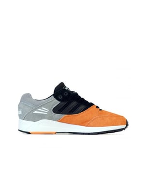 Adidas biedt een nieuwe, frisse kijk op het Tech Super-silhouet met de naam "Salmon Toe".
Sneakers in een overwegend tweekleurig ontwerp, met tonale juxtaposities van grijs suède met een sappige meloentint op de teen en voorvoet.
Afwisselend effen zwarte panelen van suède en leer in het midden voegen contrast toe aan het bovenwerk, aangevuld met een witte zachte EVA tussenzool en een zwarte buitenzool met reliëf en rode accenten.
