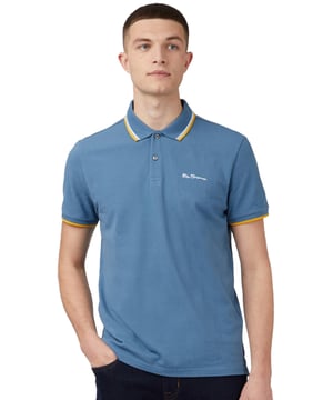 Nuestra icónica camiseta polo está confeccionada con 100% algodón orgánico, ofreciendo un look atemporal para hombres. Este diseño clásico incluye detalles en contraste en el cuello y los puños, añadiendo un toque de estilo. Cuenta con una tapeta de dos botones, un cuello de punto plano y mangas cortas. La camiseta también tiene un bordado en el pecho y está diseñada en un ajuste clásico.