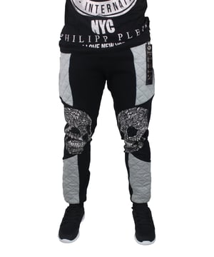 Philipp Plein HM683315 Twin Troubles 02 Sweat Pants. Black Sweat Pants. 100% Cotton. Two Large Graphic Skulls On Knees. Large Plein Tag On Front Left Pocket Zip. Made In italy
