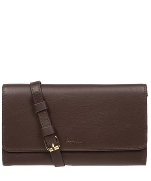 The 'Saffron' cross body clutch bag from the Pure Luxuries Marylebone collection is handcrafted from high-quality, genuine Nappa leather with a natural super-soft touch. The minimalistic fold-over top is secured by a gold-coloured magnetic press stud. The interior is lined with 100% cotton and features slip pockets and card slots to help keep an organised bag. Comes with an adjustable slim leather strap with a maximum drop length of 65cm. The strap is also removable by releasing the two interior press studs, transforming the bag into a clutch bag. Furnished with gold-coloured metal fittings. The minimalist Pure Luxuries logo is embossed in gold foil for a beautifully simple finishing touch.