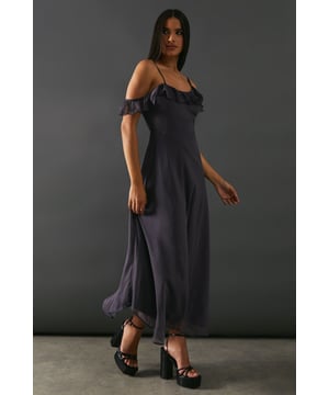 Add a touch of elegance to any occasion. With its embellished asymmetric ruffle and strappy design, it offers a unique and stylish look. The midaxi length adds a modern twist, making it perfect for both casual and formal events.