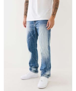 Give your look an upgrade with the Ricky Big T Crinkle Straight Jean. This pair of men’s jeans feature a vintage tie dye design, medium wash, zip fly, and Big T stitching. Finished with clean hardware and horseshoe detailing along the back flap pockets. 
