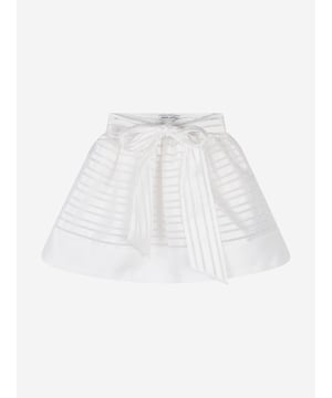 Mama Luma's sophisticated portfolio takes inspiration from a bygone era. This girls white strap skirt is both captivating and beautifully constructed. Crafted in a polka-dot bobbled effect via a chiffon effect on a peplum hem. It is complete with a tie-up bow and satin stripe trim. She will embody unparalleled confidence.  Mesh/Cotton Lining  100% Polyester