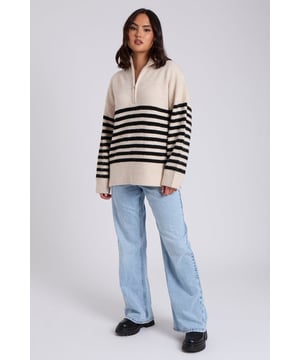 Model is 5'6 and wears a size S. Half Zip, Oversized, Stripe detail. We are excited to introduce our new Half Zip Stripe Jumper, a perfect blend of style and comfort. Featuring a contemporary half-zip design and bold stripe pattern, this jumper is versatile enough for both casual and smart-casual looks. Crafted from high-quality materials, it offers warmth and a relaxed fit, making it a staple for any wardrobe. Whether you're layering it for cooler days or making a statement on its own, the Half Zip Stripe Jumper is sure to elevate your outfit with ease and sophistication.