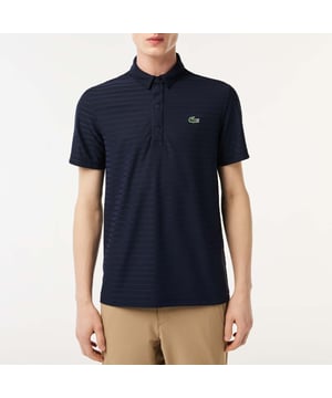Men's Lacoste SPORT Textured Breathable Golf Polo Shirt.- Breathable ultra-dry stretch jacquard jersey.- Four-button shirt style polo collar.- Length 29.6 in.- Green crocodile transfer on chest. Material: 100% Polyester. Ref: DH6844166.