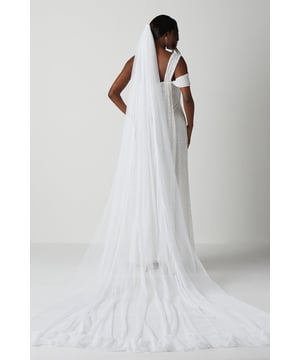 Exquisite cathedral length veil crafted from premium soft tulle mesh
Elegant ruffle hem detail adds a touch of romantic flair
Lightweight and airy fabric drapes beautifully for a dreamy look
Versatile length allows for styling options to suit your desired look
Timeless and sophisticated accessory to elevate your bridal ensemble

Radiate ethereal elegance on your special day with this exquisite cathedral length veil. The premium soft tulle mesh fabric cascades gracefully, creating a dreamy, romantic look. The delicate ruffle hem detail adds a touch of whimsy and charm, while the versatile length allows you to style it in a variety of ways to suit your desired aesthetic. Whether worn cascading down your back or draped over your face for a traditional look, this timeless accessory will elevate your bridal ensemble and ensure you exude sophistication and grace as you walk down the aisle.