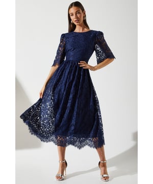 Exquisite all-over lace design
        Elegant midi length with scalloped hem
        Flattering fit-and-flare silhouette
        Short sleeves with delicate eyelash trim
        Round neckline for a sophisticated look
    
    This stunning lace midi dress from Coast is the epitome of refined elegance. Perfect for those special occasions where you want to make a lasting impression, this dress combines timeless style with contemporary flair. The intricate lace pattern adds depth and texture, while the fit-and-flare silhouette flatters your figure beautifully. Ideal for weddings, the races, or formal events, this dress can be styled to suit various settings. For a classic look, pair with strappy metallic heels and a clutch bag. Add a fascinator for race day glamour, or opt for statement earrings and an updo for a sophisticated evening ensemble. The versatility of this dress ensures it will become a treasured piece in your occasion wear collection, ready to be styled time and time again for those moments when you want to feel truly special.