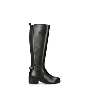 KGL Cheslea Rider from Kurt Geiger London is a knee high boot with a black leather upper. There is a gold chain at the back featuring a brass eagle head.