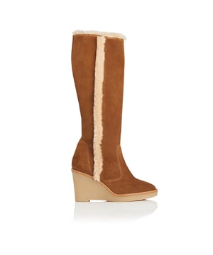 A seriously warm pair of winter boots, Margie is a knee high design crafted from a luxurious blend of tobacco suede and cream shearling. Effortlessly smartening your off-duty weekend wardrobe, these beautiful wedge heel boots feature a round toe, contrast edging and an exposed shearling trim around the top and running down the outside seam. Sturdy and stylish, they’re a welcome alternative to block heeled boots and work with tights and skirts or beneath Seventies-inspired flared trousers or jeans.