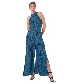 Spot Halter Neck Side Split Jumpsuit from Roman. Summer is all about pretty prints and floaty fits! Cut from a cool, woven fabric with a tie back fastening, this Dusk style has a belted waist for a figure flattering silhouette. The glamorous halter neck is perfect for styling with occasion jackets. This all in one outfit is ideal for any event, finishing with a floaty full length trouser in a wide leg shape with trendy side splits. Style with heels and a clutch bag for a statement occasion style this Summer.