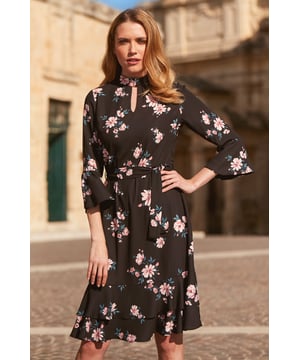 REASONS TO BUY: 

For that thing you have to go to
Florals are always in fashion
Double ruffle hem and sleeves for added drama
Waist cinching tie belt
Chic high neck, sexy cut out detail
Add court shoes and a clutch bag
