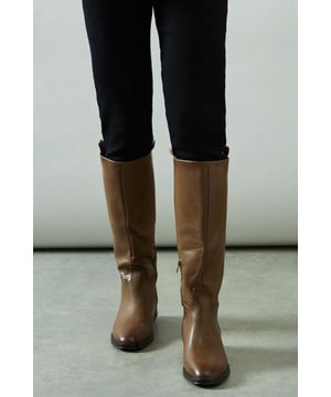 Knee-high riding boot design with sleek silhouette
        Faux leather construction for a polished look
        Distinctive stirrup detail adds equestrian flair
        Low heel measuring between 5 and 6.5cm for comfortable wear
        Side zip closure for easy on and off
    
    Step into sophistication with the Keely Faux Leather Stirrup Detail Low Heel Riding Knee Boot from Wallis. These elegant boots manifest a perfect blend of style and practicality, ideal for the woman who values both comfort and glamour. The knee-high silhouette elongates the leg, while the low heel ensures all-day wearability. Style these versatile boots with skinny jeans and an oversized jumper for a chic daytime look, or pair them with a flowing midi dress for family gatherings. The stirrup detail adds a touch of equestrian charm, making these boots a standout choice for casual outings or countryside walks. Whether you're running errands or meeting friends for brunch, these boots will keep you looking effortlessly stylish and feeling comfortable throughout your day.