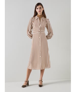 Imagine a breezy afternoon stroll wearing the Emelia candy stripe shirt dress in chocolate and birch. This stylish piece in chocolate and birch silk boasts a classic collar, full length sleeves, and a sophisticated woven stripe design, perfect for smart casual outings. Pair it with elegant flats for a daytime look or enhance it with heels for an evening out.