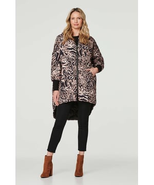 Add a statement printed puffer to your outerwear collection with this quilted drop hem coat. It has a hood, a v-neck with a zip front closure, long sleeves with cuffs, pockets and a high-low hem dropping from thigh  to knee length. Layer over almost any outfit for an on trend cold weather style.