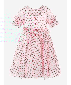 Mama Luma's sophisticated portfolio takes inspiration from a bygone era. This girls red dot dress is reflective of the Californian label's impeccable craftsmanship and precision of beauty. Crafted via an organza base with exaggerated frills, a bobbled red bow pattern, tie-up waist and elasticated cuffs. She will embody unparalleled confidence.  Red Front Button Fastening Cotton Lining 100% Polyester