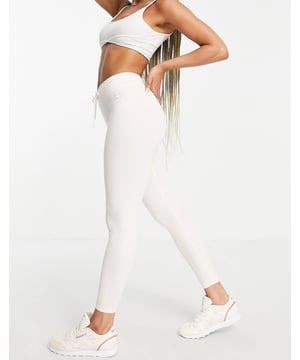 Joggers by Reebok. High rise drawstring waist Reebok logo embroidery in a bodycon fit.