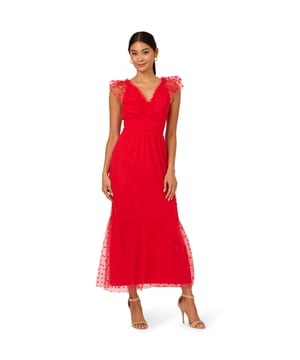 This is an ankle length soft skirt dress made out of a woven tulle fabric, with a v-neck neckline in the front, v-neck neckline in the back, sleeveless, tulle with flocked dot, a flounce hem, smocking, ruffle, shirring, tie detail at the back, and zipper at the centre back.