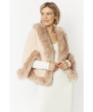 Immerse yourself in effortless luxury with this elegant, decadent faux suede cape with matching faux fur trim. Our luxurious cape can be worn to complete a modern layered look on those chilly days.