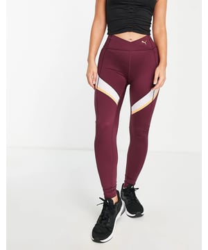 Leggings by PUMA. High rise elasticated waist side slip pocket contrast panels full length and bodycon fit.