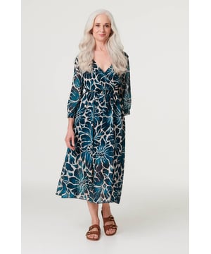 This versatile floral maxi dress can be styled effortlessly for daytime and evening events. It has a pleat front v-neck, 3/4 sleeves, mesh layered hem and buckle details. Throw on a jacket for a stylish look whether you're at the office or out for dinner.