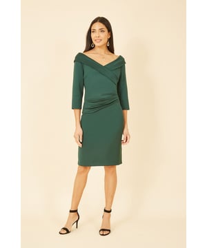 Make an entrance to any formal occasion this season in the Yumi Green Scuba Fitted Wrap Dress. The ultra flatting shape of the wide V neckline is finished with a 3/4 sleeve and zip detail in the back. The ruching at the waistline enhances the silhouette further and with a chic hemline to the knee, this is perfect to dress up with a statement heel and bag.