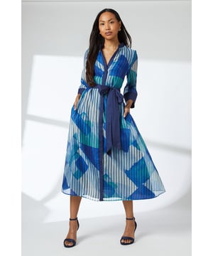 Striking geometric print in vibrant hues
        Collarless neckline for a modern twist
        Three-quarter length sleeves with contrasting cuffs
        Belted waist for a flattering silhouette
        Midi length with a flowing A-line skirt
    
    This eye-catching shirt dress from Principles is a versatile addition to your wardrobe. The bold geometric print creates a captivating visual impact, while the collarless design adds a contemporary edge. Perfect for daytime events, this dress can be styled for various casual occasions. Pair it with flat sandals and a woven tote for a relaxed family gathering, or dress it up with block-heeled mules for lunch with friends. The belted waist allows you to customise the fit, accentuating your figure. For cooler days, layer with a lightweight cardigan or denim jacket. The midi length offers both comfort and style, making it suitable for a range of social settings from weekend brunches to casual office environments. This Principles dress effortlessly combines comfort and style, ensuring you look polished for any daytime engagement.