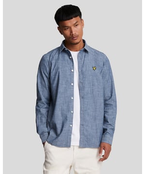 If you’re building a capsule wardrobe, a chambray shirt should be at the top of your shopping list. The versatile shirt is woven from cotton chambray, which is a plain-weave fabric made with a dyed warp yarn giving it a relaxed vibe. Ours has a front button fastening and a classic collar. The only extra detailing is our signature golden eagle logo at the chest. - Classic collar 
- Front button fastening 
- Long sleeves with button cuffs
- Composition: 100% cotton