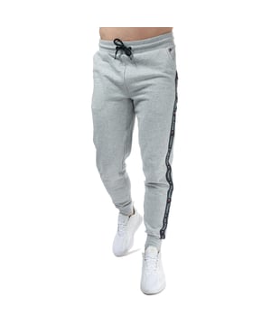 Mens Tommy Hilfiger Repeat Logo Tape Jog Pants in grey.- Elasticated drawstring waist. - Two front slit pockets.- Tommy Hilfiger repeat logo tape at sides.- Rib-knit waistband and cuffs.- Signature drawstring ends.- Tommy Hilfiger flag embroidery on pocket.- 75% Cotton  25% Polyester.  Machine washable. - Ref: UM0UM00706004