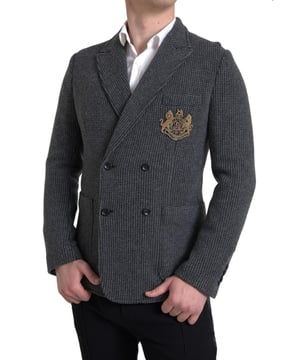 Brand: Dolce & Gabbana
  Style: Double-breasted blazer
  Fitting: Slim fit
  Color: Gray
  Logo embroidery on the chest
  Peak lapel style
  Double-breasted closure with two buttons
  Material: 100% Cashmere
  Made in Italy
Material: 100% Cashmere