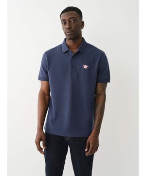 Pop that collar with the Buddha Patched Logo Polo Shirt. Crafted from soft cotton, this men’s polo features a basic collar. half-button placket, and short sleeves. Finished with a relaxed fit, ribbed trim, and a chest Buddha patch.