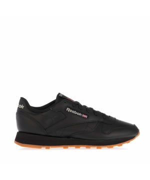 Womens Reebok Classics Classic Leather Trainers in black.- Leather upper.- Lace closure.- Lightweight cushioning.- Mid-cut design.- Padded tongue and cuff.- Signature Reebok branding.- Removable sockliner.- Die-cut EVA midsole.- Textured grip tread.- Durable rubber outsole.- Ref.: GY0961