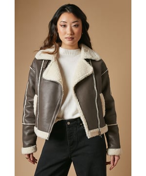 Striking contrast borg detailing for added warmth and style
        Asymmetrical zip front closure for a modern edge
        Oversized collar for a bold, fashion-forward look
        Cropped length perfect for layering
        Versatile design suitable for various casual occasions
    
    This PU borg detail collared zip jacket from Oasis is the epitome of cool-weather chic. The contrasting borg lining not only adds a cosy touch but also creates a striking visual appeal. Its asymmetrical zip closure and oversized collar lend a contemporary edge to your ensemble. The cropped silhouette is ideal for showcasing high-waisted bottoms, as demonstrated by the model pairing it with wide-leg trousers. For a casual day out, style it with your favourite jeans and trainers. Alternatively, dress it up for an evening with friends by layering it over a fitted dress and ankle boots. This jacket is a versatile piece that will quickly become a go-to in your autumn and winter wardrobe, perfect for family gatherings, weekend brunches, or casual outings where you want to make a stylish statement without compromising on comfort.