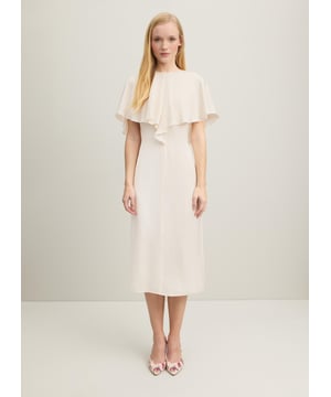 Light and luscious, the new Sadie dress in our Royal Ascot collection whispers elegance and timelessness. Crafted from a beautiful lightweight and floaty fabric in classic cream, it has a round neck with butterfly cape detail over the shoulders and a slim silhouette falling to the knee. Wear it for a day at the races, and all the big moments in your 2024 diary.