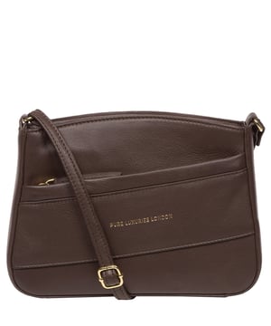 The 'Helena' cross body bag from the Pure Luxuries Marylebone collection is handcrafted from high-quality, genuine Nappa leather with a natural super-soft touch. The zip-over top opens to reveal a 100% cotton-lined interior. The spacious compartment features two slip pockets to help maintain an organised bag. A zipped pocket on the front of the bag provides on-the-go storage. Features gold-coloured metal fittings and zips alongside the adjustable slim leather strap, with a maximum drop length of 65cm. The Pure Luxuries logo is embossed in gold foil for a beautifully simple finishing touch.