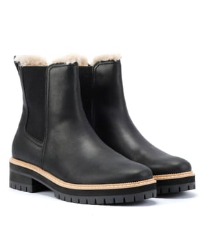 Chelsea lug boots featuring water-resistant Nubuck leather uppers, CloudBound™ foam insoles for superior cushioning, and a cozy faux-fur lining. The stacked heel adds style and support. TOMS is a proud member of the Fair Labor Association.