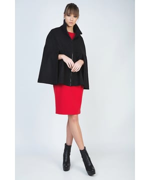 Winter cape in black woven fabric. Fastens in the front with a decorative black plastic zip. Upright colour. Openings for the arms under the bust. Loose fit. Fully lined in black woven fabric. Our model has height 178 cm and wearing size 36. Measurements for size 38 (in cm):Bust-66; Body length-68; Waist-86; Hemline-96. Garment is loose fitted.