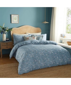 Transform your bedroom into a serene retreat with the Bronte Floral Duvet Cover Set. Crafted from 100% cotton and featuring a 144-thread count, this duvet cover combines comfort with timeless elegance. The classic English garden ditsy print showcases delicate lilac forget-me-nots and subtle foliage, offering a refined touch that speaks to lovers of nature and understated beauty. The same exquisite design graces both sides, allowing it to stand alone as a statement piece. With Bronte, experience the perfect blend of sophistication and natural allure that invites tranquillity and style into your living space. 200 x 200cm