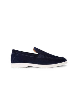 This KG Kurt Geiger Ryan is a navy suede slip on loafer with sleek upper. There is embossed branding on the back of the ankle.