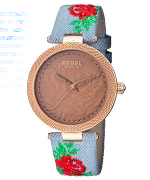 “W   hy fit in when you were born to stand out?”           This line, which is quoted on the caseback of the watch, is the essence of the Carrol Gardens collection. The dial with its leather look embossed with roses complements the canvas covered leather band with a floral print design. You were born to stand out and with this watch you will achieve your aspirations.Rebel Carroll Gardens Brown Dial Women's Watch RB112-8191
Rebel Women's Watch from the Carroll Gardens Collection
Round 316L Stainless Steel Rose Case
Brown Dial, Mineral Crystal
Light Blue Cloth Band with Tang Buckle
Water Resistance: 5 ATM (50 meters, 165 feet)
9mm Case Thickness, 40mm Case Diameter, 20mm Band Width
Quartz Movement
