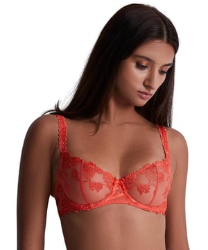 Welcome to the world of luxury lingerie with the Aubade Softessence triangle bra, a stunning half-cup bra designed to make you feel confident, comfortable, and oh-so-stylish. Crafted with intricate floral embroidery, this bra blends femininity with sensuality. The delicate blooms dance across the soft tulle mesh, creating a mesmerizing effect that is both alluring and dreamy. But luxury doesn't have to mean sacrificing comfort. That's why this bra is underwired for unbeatable support while remaining non-padded for a natural look and feel. A lace-up design adds a playful, flirty touch to this stunning piece. And let's not forget about the cute bow at the centre front, adding a touch of charm. The decorated adjustable shoulder straps ensure that this bra will stay in place all day long, providing you with comfort and support. Plus, there are now matching briefs available to complete this glamorous look.

Half cup bra
Floral embroidery design
Semi-sheer tulle mesh
Scalloped edging
Underwired for support
Non-padded for comfort
Lace-up design
Cute bow at the centre front
Decorated adjustable shoulder straps
Hook and eye closure
Matching coordinates available
Country of origin: Tunisia
Composition: Cup embroidery: 64% Polyester | 36% Polyamide
Composition: Back embroidery: 47% Polyester | 38% Polyamide | 15% Elastane
Composition: Centre embroidery: 46% Polyamide | 35% Polyester | 19% Elastane
Composition: Lining: 100% Polyamide
Listed in UK sizes
 Half Cup Bra