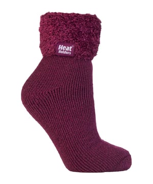 Lounge around the home in these cosy socks. Whether you're looking to stay warm or comfortable indoors, these lounge socks feature a cute and stylish design so you can pair them with any casual outfit! Every Heat Holders® sock, including these lounge socks, are created by UK PATENTED knitting technology. This unique manufacturing process together with Heat Holders® innovative Japanese designed thermal yarn ensures maximum warmth is held close to the skin, keeping your feet warmer for longer. With a strong TOG rating of 2.34, these socks are designed to keep your feet warm as well as retain heat close to the skin. They also prevent your feet from feeling clammy with their soft brushed inner thermal lining. With long pile cushioning, these thermal socks will help keep feet fully comfortable and supported. Heat Holders are made from a specially developed heavy bulk yarn which has extreme thermal-like qualities. These socks would make the perfect gift for any woman who suffers cold feet! Choose from our different colours and styles to suit your woman's fashionable needs! Why not treat yourself to these lovely pair of cosy socks to wear in bed? Featuring a turn over cuff, you can pull up or roll down these socks for a much more comfortable fit! These socks also have a low cut ankle length so you can subtly show off your socks! Stop sliding or slipping on wooden or tiled floors with these non-slip gripped socks. They feature a rubber-like non-slip grip so you can walk around the home comfortably. These socks are available in womens sizes 4-8 UK
