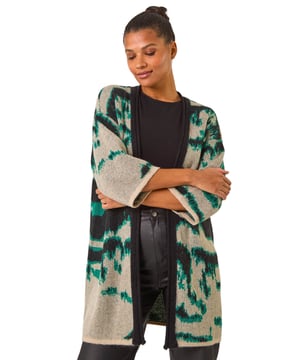Abstract Print Knit Cover Up from Roman. Stay stylish and warm with this abstract knit cover up, perfect for the Autumn/Winter season. Designed with an eye catching abstract knit pattern, this cover up features an easy edge to edge front and chic short sleeves for a versatile look. Layer it over a long sleeve top and jeans for a fashionable and cosy outfit.