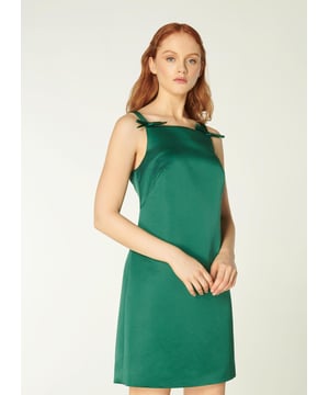 Short and chic, our Amalfi dress is a sumptuous new style in our partywear collection this season. Crafted from beautiful emerald green Italian satin, this statement dress has a square neckline, vintage-inspired bow detail to the straps, a close fit and a short, above the knee cut. Wear it with a sharp pair of flats or a towering pair of strappy sandals.