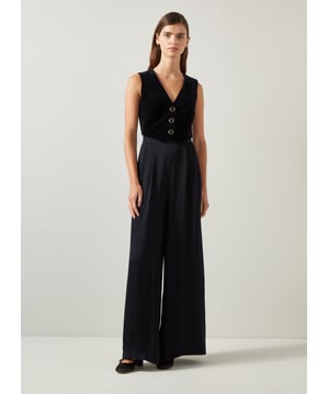 Be the center of attention with the Carine waistcoat culotte jumpsuit, ideal for evening events. In sleek black, this cotton blend jumpsuit boasts a v-neck, sleeveless design, mixed media details, and convenient pockets with a back zip. Combine it with statement heels and a clutch for an effortlessly stylish appearance.