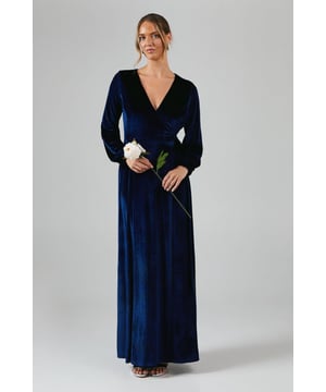 Luxurious velvet fabric for a sumptuous feel
        Elegant wrap neckline for a flattering silhouette
        Long sleeves with subtle gathering at the cuffs
        Floor-length design for a graceful, sweeping look
        Part of the exclusive Coast x Debut London collection
    
    Embrace sophistication and grace in this stunning bridesmaids dress from the Coast x Debut London collection. The wrap-style bodice creates a beautifully feminine silhouette, while the long, flowing skirt adds a touch of drama to your ensemble. Perfect for the bridal party, this dress is designed to complement the bride while allowing you to shine in your supporting role. Style with delicate drop earrings and an elegant updo to complete your look. The versatile design ensures you'll feel comfortable and confident throughout the wedding festivities, from the ceremony to the last dance. This dress is a testament to Coast's commitment to creating occasion wear that combines timeless elegance with contemporary flair, making it an ideal choice for the discerning bridesmaid who appreciates quality and style.