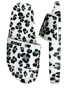 These sliders effortlessly combine comfort and fashion, making them a versatile choice for any casual occasion. 

Featuring a clean and sleek design, the white synthetic strap adds a touch of minimalist elegance to your look. The contrasting black Slydes branding on the strap adds a subtle pop of visual interest, creating a dynamic and trendy aesthetic.

Designed for easy slip-on wear, these sliders provide convenience without compromising on style. The comfortable footbed molds to the shape of your feet, ensuring a personalized fit and all-day comfort. Whether you're relaxing by the pool, taking a stroll, or running errands, these sliders offer a hassle-free and comfortable experience.

The durable rubber outsole provides reliable traction, allowing you to move with confidence on various surfaces. Whether you're walking on the beach or exploring the city streets, these sliders ensure stability and support.

Embrace the understated yet chic look of the Slydes Blur Women's White/Black Sliders. Perfect for pairing with your favorite summer outfits, these sliders effortlessly complement a wide range of styles. Step out in style and comfort, as you make a fashion statement with these trendy and versatile sliders from Slydes.