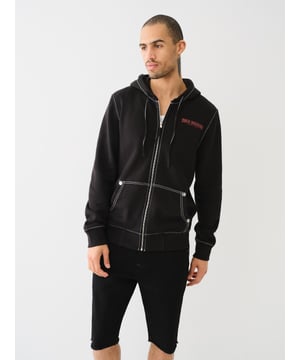 Stay warm in the on-trend Painted Horseshoe Zip Hoodie. This fleece hoodie features a zip-up front, drawstring hood, Big T stitching, long sleeves, and a split kangaroo pocket. Finished with a statement-making painted horseshoe graphic on the back. 