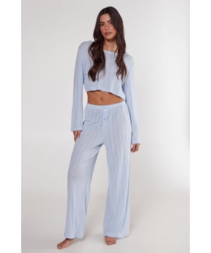 Stylish pointelle knit pattern for a delicate, feminine touch
        Cropped long-sleeve top for a modern, trendy silhouette
        Wide-leg trousers with button detailing for added comfort
        Soft jersey fabric ensures all-night cosiness
        Versatile two-piece set perfect for lounging or sleeping
    
    Embrace laid-back luxury with this chic Pointelle Long Sleeve Cropped Top And Trouser Pajama Set from NastyGal. The intricate pointelle knit pattern adds a touch of elegance to your nightwear collection, while the cropped top and wide-leg trousers create a fashionable silhouette that's both comfortable and on-trend. Crafted from soft jersey fabric, this set is ideal for those who appreciate style even in their most relaxed moments. Whether you're having a cosy night in or hosting a casual pyjama party with friends, this set strikes the perfect balance between comfort and style. Layer with a fluffy dressing gown for chilly evenings, or pair the top with your favourite jeans for a casual daytime look. This versatile set is a must-have addition to your loungewear wardrobe, offering endless styling possibilities for your downtime.